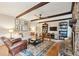 Inviting living room with exposed wood beams, fireplace, and hardwood floors at 614 Beauregard St, Charleston, SC 29412