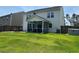 Spacious backyard featuring a screened-in porch and lush lawn, providing ample outdoor living and recreation space at 677 Redbud Ln, Summerville, SC 29486