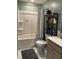 Well-organized bathroom with a shower-tub combination, decorative shelving, and neutral-toned decor at 677 Redbud Ln, Summerville, SC 29486