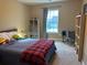 Cozy bedroom featuring a comfy bed, carpeted floors, and a well-lit workspace at 677 Redbud Ln, Summerville, SC 29486