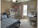 Bright bedroom featuring a black metal bed frame, carpeted floors, and a well-lit workspace at 677 Redbud Ln, Summerville, SC 29486