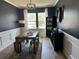 Elegant dining room featuring a wooden table, paneled walls, wainscoting, and modern decor at 677 Redbud Ln, Summerville, SC 29486