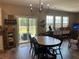 Cozy dining area featuring wood floors, a modern chandelier, and sliding glass doors to the outdoor patio at 677 Redbud Ln, Summerville, SC 29486