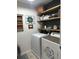 Well-organized laundry room with shelving and modern appliances, plus charming decor and a practical design at 677 Redbud Ln, Summerville, SC 29486