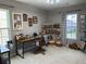 Bright office space with neutral walls, work desk, and peg board storage system, plus natural light from the windows at 677 Redbud Ln, Summerville, SC 29486