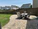 Paver patio with an outdoor dining set and wooden fence, perfect for entertaining and enjoying the outdoors at 677 Redbud Ln, Summerville, SC 29486