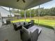 Relaxing screened porch boasts comfortable seating and views of the spacious, fenced backyard at 677 Redbud Ln, Summerville, SC 29486