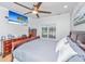 This bedroom has a ceiling fan, a dark wood bed frame, and a dresser with a flat screen television on the wall at 69 King Charles Cir, Summerville, SC 29485
