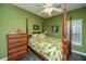 Green bedroom featuring a four-poster bed, a ceiling fan with lights, and vintage decor at 69 King Charles Cir, Summerville, SC 29485