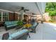Spacious covered patio with comfortable seating, ceiling fans, and views of the beautifully landscaped backyard at 69 King Charles Cir, Summerville, SC 29485