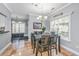 Elegant dining area with a modern chandelier and windows that provides natural light at 69 King Charles Cir, Summerville, SC 29485