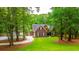Charming brick home with lush landscaping, mature trees and a curved driveway at 69 King Charles Cir, Summerville, SC 29485