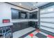 Well-organized garage featuring a work area, cabinets, and a sleek black and gray color scheme at 69 King Charles Cir, Summerville, SC 29485