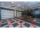 Spacious garage with ample storage, a ping pong table, and a stylish tiled floor at 69 King Charles Cir, Summerville, SC 29485