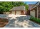 Spacious garage with multiple bays, ample parking, and an adjacent brick-walled area at 69 King Charles Cir, Summerville, SC 29485