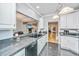 Open-concept kitchen features granite countertops, white cabinetry, and views of the living area at 69 King Charles Cir, Summerville, SC 29485