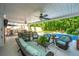 Large, covered patio with seating and dining areas overlooking a luxurious pool and lush backyard at 69 King Charles Cir, Summerville, SC 29485