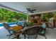 Inviting covered patio with comfortable seating, a brick fireplace, and a view of the pool at 69 King Charles Cir, Summerville, SC 29485