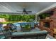 Spacious covered patio with outdoor furniture and a beautiful view of the pool and greenery at 69 King Charles Cir, Summerville, SC 29485