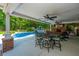 Covered patio featuring an outdoor dining area, lounge seating, and a view of the pool and backyard at 69 King Charles Cir, Summerville, SC 29485