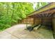 Covered outdoor storage area with concrete flooring surrounded by lush greenery and mature trees at 69 King Charles Cir, Summerville, SC 29485