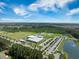 Expansive aerial view of the recreation center, parking lot, sports fields, and surrounding woodlands at 705 Squire Pope Rd, Summerville, SC 29486