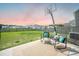 Large backyard features a basketball hoop and patio with comfortable seating, creating a great space for relaxation and outdoor activities at 705 Squire Pope Rd, Summerville, SC 29486