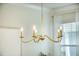 Elegant gold chandelier illuminates the dining area with a warm glow at 705 Squire Pope Rd, Summerville, SC 29486