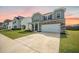 Two-story home features a stone facade, a two-car garage, and a well-maintained lawn at 705 Squire Pope Rd, Summerville, SC 29486