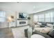 Cozy living room features a fireplace, plush sofa, and ample natural light at 705 Squire Pope Rd, Summerville, SC 29486