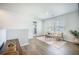 Bright upstairs living room with two armchairs, hardwood floors, and a large window at 705 Squire Pope Rd, Summerville, SC 29486