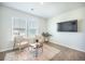 Bright living room featuring two armchairs, a modern coffee table, and large windows at 705 Squire Pope Rd, Summerville, SC 29486