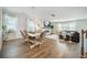 Open-concept living space with dining area, hardwood floors, and a cozy fireplace at 705 Squire Pope Rd, Summerville, SC 29486