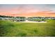 Scenic pond reflecting the surrounding homes and vibrant sky, creating a tranquil and picturesque neighborhood view at 705 Squire Pope Rd, Summerville, SC 29486