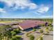 Aerial shot of the exterior of the building, parking area, and surrounding land and neighborhood at 705 Squire Pope Rd, Summerville, SC 29486