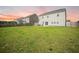 Expansive backyard featuring lush green grass, a fenced perimeter, and a patio area perfect for outdoor relaxation at 705 Squire Pope Rd, Summerville, SC 29486