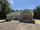 Back exterior featuring a covered porch and spacious lot, offering relaxing outdoor living and views of surrounding trees at 729 Burlington Rd, Walterboro, SC 29488