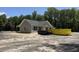 Single-story home with a covered porch, gray siding, black shutters and a large lot surrounded by green trees at 729 Burlington Rd, Walterboro, SC 29488