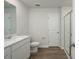 Bathroom features a modern single sink vanity, a toilet, a shower with glass doors and wood look floors at 737 Meadowbrook Ln, Summerville, SC 29486