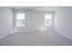 Bright bedroom featuring neutral carpet and two windows for ample natural light at 737 Meadowbrook Ln, Summerville, SC 29486