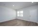 Bright, empty bedroom featuring light hardwood flooring, recessed lighting, and one window overlooking the yard at 737 Meadowbrook Ln, Summerville, SC 29486