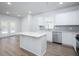 Modern kitchen featuring white cabinets, an island, stainless steel appliances, and sleek countertops at 737 Meadowbrook Ln, Summerville, SC 29486