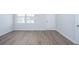 Unfurnished living room showcasing wood-look floors, white trim, and a door to the backyard at 737 Meadowbrook Ln, Summerville, SC 29486
