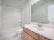 Well-lit bathroom featuring a shower-tub combo, single vanity, and a large mirror at 743 Redbud Ln, Summerville, SC 29486