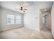 Light-filled room with a ceiling fan, a window, and neutral carpet flooring, providing a cozy space at 743 Redbud Ln, Summerville, SC 29486