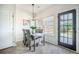 Cozy dining area features a modern chandelier, wood-look floors, a wooden table, and a backyard view at 743 Redbud Ln, Summerville, SC 29486
