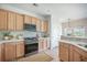 Bright kitchen featuring natural wood cabinets, quartz countertops, tile backsplash and stainless steel appliances at 743 Redbud Ln, Summerville, SC 29486