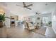 Open-concept living room with hardwood floors, ceiling fans, and a seamless flow to the kitchen at 743 Redbud Ln, Summerville, SC 29486