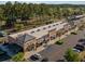 Overhead shot of a retail strip with restaurants, parking lot, and surrounded by tall pine trees at 743 Redbud Ln, Summerville, SC 29486