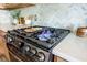 Close up on gas cooktop, showing its functionality and design with quartz countertops and herringbone backsplash at 743 Redbud Ln, Summerville, SC 29486